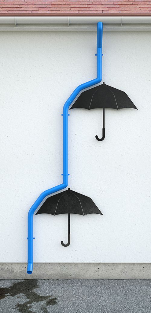 水色の排水管が、雨水のように、壁に掛けた黒い傘に弾かれ滴り落ちている。のが遊び心があって面白い！
